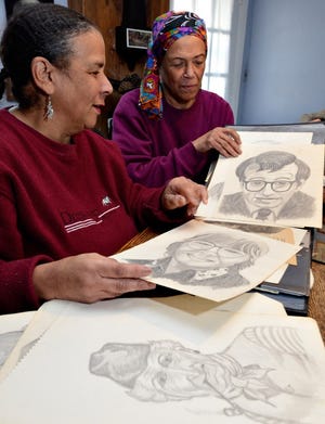 Judith Stratton and her sister Doreen look through drawing that their mother, Dorothy Stratton completed through out her life at their Doylestown home Saturday. The Stratton family has been Doylestown residents for over a hundred years. They and others will be recognized Monday when Doylestown Borough passes a resolution marking February as African American History Month.