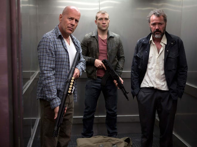 This publicity film image released by 20th Century Fox shows Bruce Willis as John McClane, left, Jai Courtney as his son Jack, center and Sebastian Koch as Komarov in a scene from "A Good Day to Die Hard."