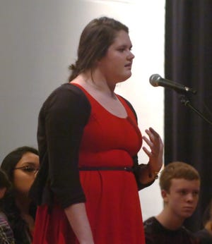 John Huff/Staff photographer

Senior Courtney Couillard wins the Poetry Out Loud competition at Dover High School Thursday and will compete in the regionals representing Dover.