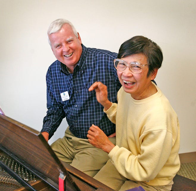 Ed Burke of Quincy, a retired state trooper, has been volunteering at the Kennedy Senior Center in North Quincy and is a hit with the seniors. Above, Burke and Anh Nguyen laugh it up while sitting at the piano in the center’s community room. The photo was taken on Monday. Jan. 28, 2013.