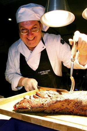 A Better Choice Catering owner Larry Metzger of Rockton smiles while slicing beef tenderloin Saturday, March 6, 2010, during Hononegah High School's HOPE Foundation 10th annual Touch of Spring fundraiser at the American Center Banquet Hall in Rockton.