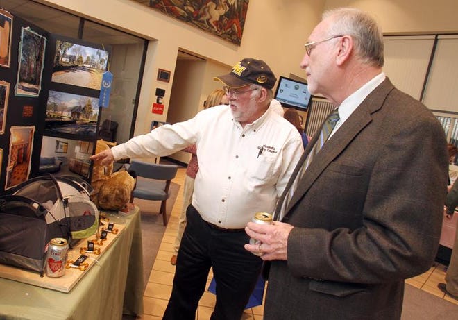 Mike Brown shares information about Hound’s Gateway Campground with Tom Keller at the 2013 Kings Mountain Business Showcase at Kings Mountain City Hall on Tuesday. (Brittany Randolph/The Star)