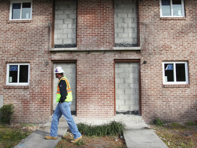 Project Superintendent Jeremy Schulz walks past apartments that are being renovated at Gardenia Gardens Apartments on Monday, February 4, 2013 in Gainesville, Fla.