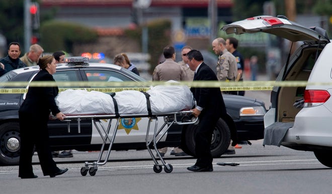 The Orange County coroner's office wheels a body to a waiting van in Orange, Calif., Tuesday, Feb. 19, 2013. Police say a chaotic 25-minute shooting spree through Orange County left a trail of dead and injured victims before the shooter killed himself.