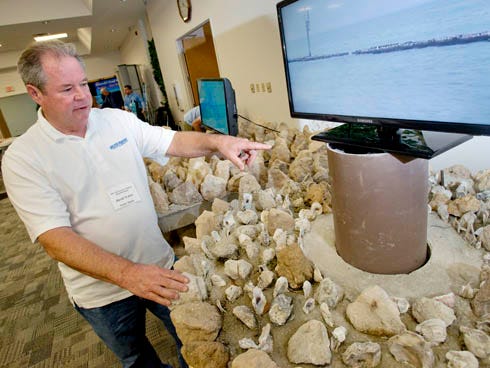 David Walter with Walter Marine of Orange Beach, Ala., describes one of his artificial reef systems Wednesday during the 2013 Northwest Florida Artificial Reef Workshop at the Niceville Community Center. The doughnut-shaped limestone and concrete structure sits on a piling and can be mounted above the ocean floor so snorkelers can swim to it easily.