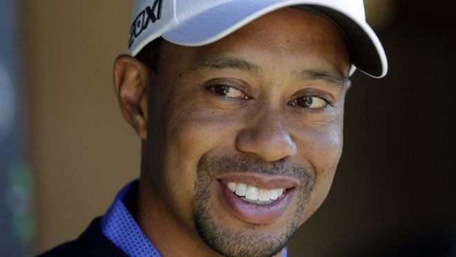 Tiger Woods smiles during a news conference before playing a practice round for the Match Play Championship golf tournament, Tuesday, in Marana, Ariz. (AP Photo/Julie Jacobson)