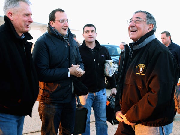 Outgoing Defense Secretary Leon Panetta, right, talks with Marine Lt. Gen. Thomas Waldhauser, left, and assistant Defense Department press secretary Carl Woog, second from left, before boarding a E-4B aircraft at Andrews Air Force Base, Md., Wednesday, Feb. 20, 2013, before traveling to Brussels for a NATO defense ministers meeting. (Chip Somodevilla | Associated Press)