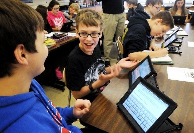 Seventh-graders Warren Livingston and Tyler Conway work on a lesson using iPads in Lynn Russman's science class at Central Valley Middle School.