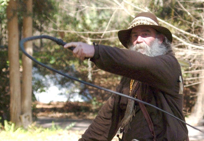 Robert Wilson, portraying a trapper or trader, cracks a bullwhip during the 2010 Cracker Days event at Rainbow Springs Park.