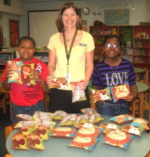 Kiwanis K-Kids club members Jada Calloway and Germari Rickerson with the comfort pillows they. They are pictured with school guidance counselor Bailey Benoit. Contributed photo.