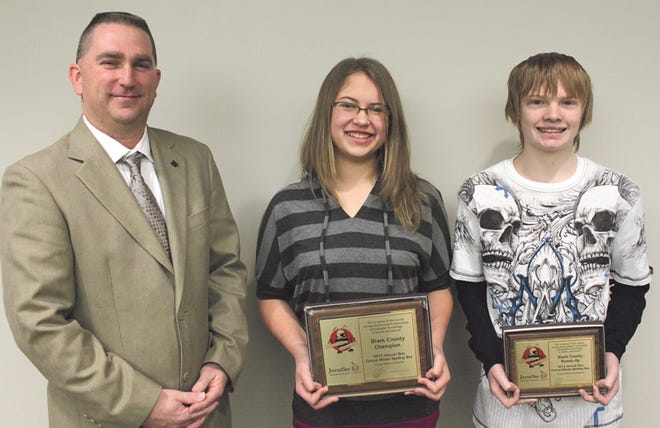 Stark County Junior High eighth grader Grace Klooster, center, is the county spelling bee champion. Bradford eighth grader David Winter, right, was the runner-up. Bureau, Henry and Stark County Regional Assistant Supt. Brad Hulick presented the trophies.