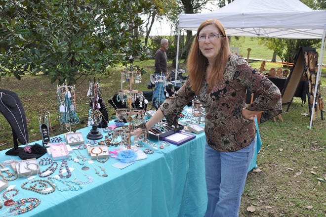 Linda Madere shows off her creations during a River Region Art Association Art Gumbo Market. The River Region Art Association is now accepting vendor applications for the Art Gumbo Market 2013.