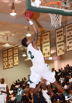 Kinston's Josh Dawson (2) attacks the rim early in Friday's EP2A boys championship against Farmville Central at Kinston High School.