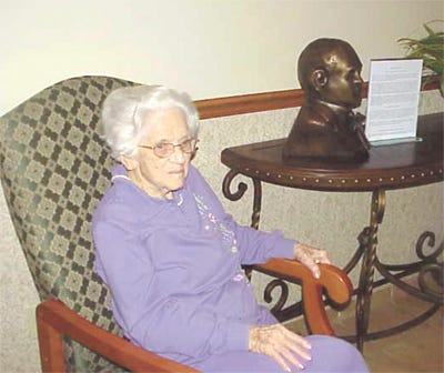 Catherine (Crum) Larson relaxes in the “great room” at Galva’s Courtyard Estates beside the recently released bronze bust of George Fitch, Galva native whose “Siwash Stories,” about his years at Knox College, were the basis of the 1940 William Holden film “Those Were the Days.” Catherine was a sophomore at Knox in 1937 when she was hired as an ‘extra’ in the film which was shot on location in Galesburg. Galva sculptor Jordan Murray completed the Fitch bust, the latest in his “Heroes in Galva” series.