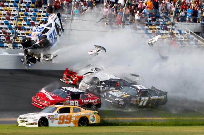 Kyle Larson (32) goes into the catch fence during a crash involving, among others, Justin Allgaier (31), Brian Scott (2), Parker Klingerman (77) and Dale Earnhardt Jr. (88) at the conclusion of the NASCAR Nationwide Series race on Saturday at Daytona International Speedway in Daytona Beach, Fla.