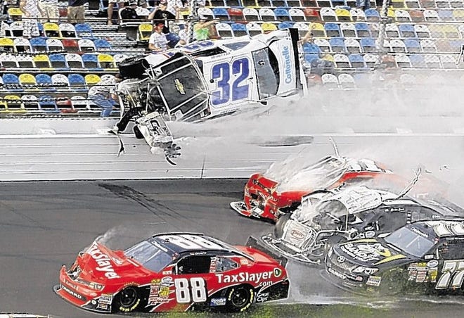 Kyle Larson (32) goes airborne and into the catch fence in a multi-car crash involving Dale Earnhardt Jr. (88), Parker Kligerman (77), Justin Allgaier (31) and Brian Scott (2) during the final lap of the NASCAR Nationwide Series auto race at Daytona International Speedway, Saturday, Feb. 23, 2013, in Daytona Beach, Fla. (AP Photo/John Raoux)