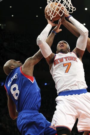 The Knicks' Carmelo Anthony (7) goes up against the 76ers' Damien Wilkins during the first half of Sunday night's game at Madison Square Garden.