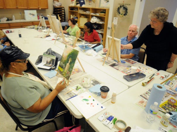 Daisy McBroom (left) paints with others during a class at the Brunswick Center at Southport Friday, February 22, 2013.