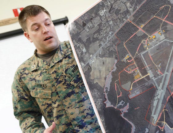 Capt. David Thomas, airfield operations officer, describes the layout of Marine Corps Auxiliary Landing Field Bogue recently.