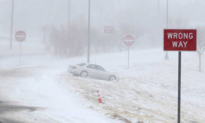 A car sets abandoned on the Interstate 27 access road during blizzard conditions on Monday in Lubbock. Wintry weather conditions in the Hub City on Monday, shut down highways and kept people at home and away from Lubbock businesses.