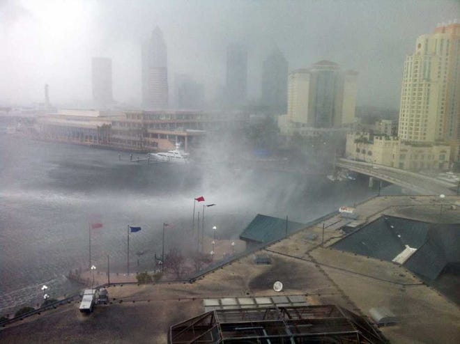 In this photo made available by Dr. Robert Seigel, a waterspout comes ashore in downtown Tampa, Fla., Tuesday Feb. 26, 2013. The National Weather Service warned of a risk of severe weather as a cold front moved across west-central and southwest Florida. (AP Photo/ Dr. Robert Seigel)