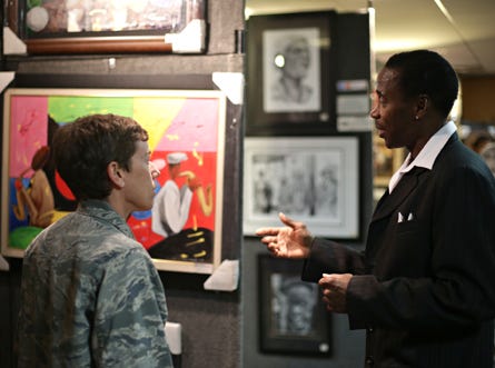 Local artist Ricky Steele talks about his paintings with Lt. Col. Shannon Phases on Tuesday at Tyndall Air Force Base.