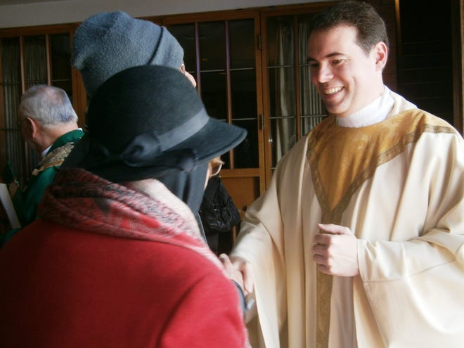 The Rev. Shawn Allen greets parishioners at St. Theresa's parish in Billerica. Wicked Local photo by Mary K. McBride