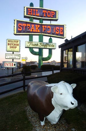 The 68-foot tall neon cactus and fiberglass cows serve as beacons that draw thousands of customers to the Hilltop Steak House each year.