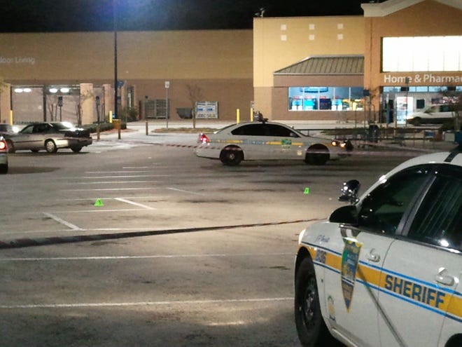 Police cordoned off part of the Walmart parking lot at 8808 Beach Blvd. Tuesday night as they investigated an earlier shooting that left Anthony Blake Bannister dead. The green markers on the pavement indicate the location of evidence, such as spent bullet casings.