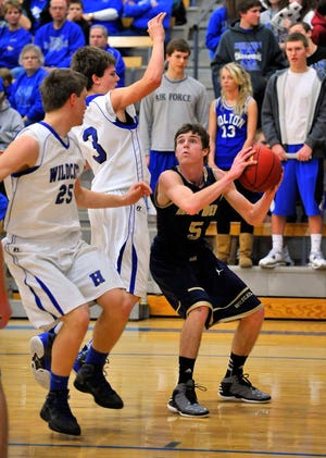 Hayden's Conner Beck looks to put up a shot against Holton's Trent Tanking, middle, and Ryan Haefke on Wednesday at Holton. Holton ended Hayden's season with a 54-49 win.
