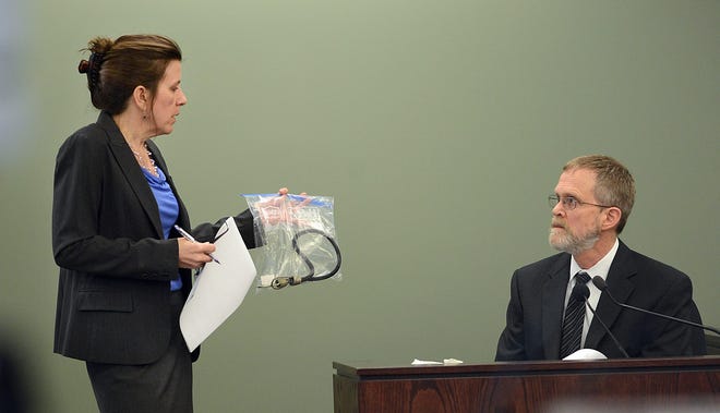 Prosecutor Lisa McGovern, left, shows a bungee cord to Massachusetts state Medical Examiner Dr. Henry Nields during during testimony in the murder trial of Nathaniel Fujita on Wednesday in Middlesex Superior Court in Woburn. Fujita is accused of killing his ex-girlfriend, Lauren Astley in July 2011. (AP Photo/MetroWest Daily News, Ken McGagh, Pool)