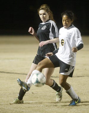 Havelock's Dominique Martinez, right, plays the ball in front of New Bern's Keely Klicker on Thursday.