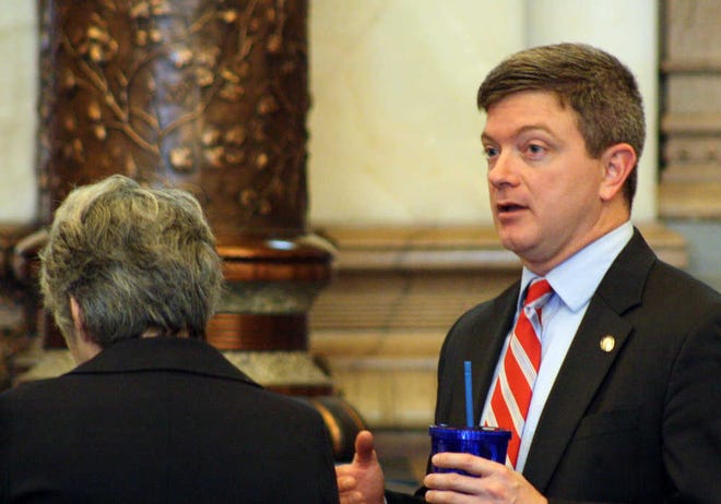 Kansas Senate Vice President Jeff King visits with Sen. Marci Francisco, a Lawrence Democrat, on Thursday. King, an Independence Republican, is the author of a bill approved by the Senate requiring applicants seeking welfare benefits to be subjected to drug screening, testing and treatment.