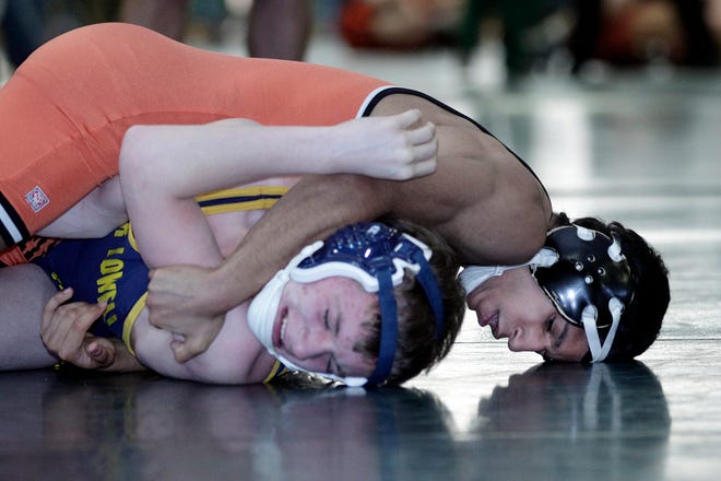 Marlborough's Omar Vazquez (top) attempts to pin Greater Lowell's Ryan Witala in the state Division 2 wrestling tournament.