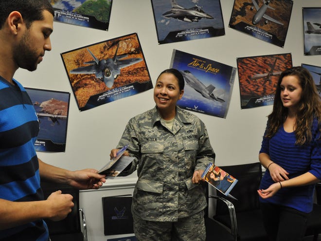 Air Force Sgt. Rita Vitela explains some of the programs offered by the military recently at the recruiting office in Volusia Mall in Daytona Beach to Dali Ramos, 23, left, and Taylor Jordan, 20. Jordan, a 2011 graduate of Mainland High School, was a member of the school's Air Force JROTC program and has always been interested in serving her country.