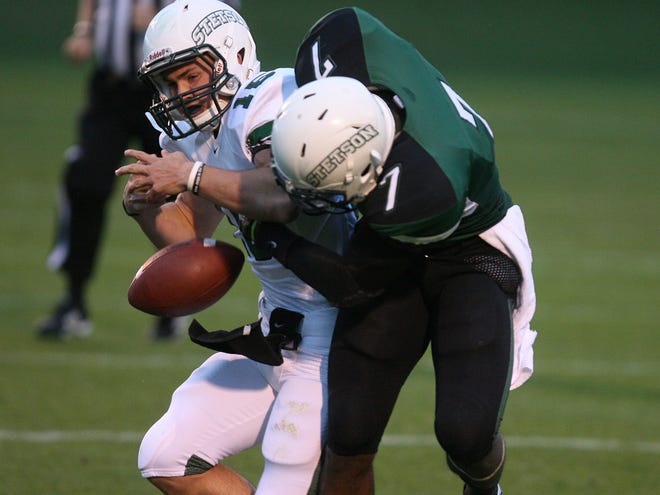 Donald Payne (7) hits white team quarterback Ryan Tentler (15) causing a fumble Friday during the Stetson Green-White spring intrasquad game in DeLand.