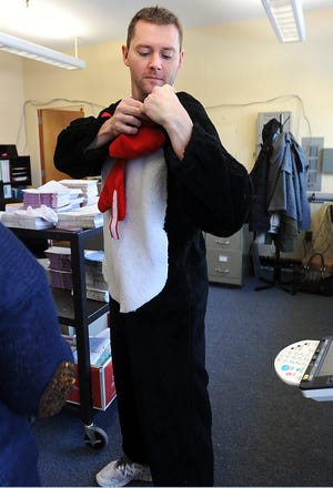 Parent volunteer Joe Cunningham of Milford suited up as The Cat in the Hat to pass out free books to students at Milford's Memorial Elementary School in celebration of Dr. Seuss' birthday which is on Saturday. He even visited the kindergarten classroom of his son, Braeden, who knew in advance that what his father was doing but completely forgot that it wasn't the actual Cat when he showed up.
