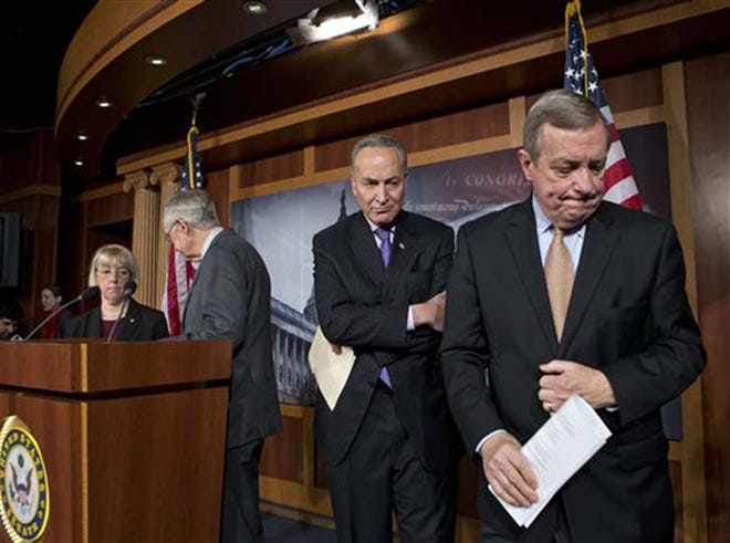 Senate Democratic leaders finish a news conference on Capitol Hill in Washington Thursday after answering questions about the impending automatic spending cuts that take effect March 1. From right to left are, Senate Majority Whip Sen. Richard Durbin of Ill., Sen. Charles Schumer, D-N.Y., Senate Majority Leader Harry Reid of Nev., and Sen. Patty Murray, D-Wash.