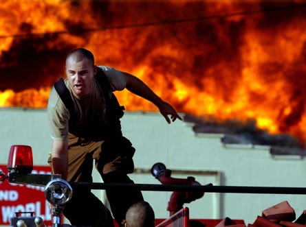 Springfield firefighter Eric Greenwood prepares to jump from the top of his as flames engulf the Citadel Center at U.S. Business 98 and Everitt Avenue in Springfield in 2009. A fire a few blocks away destroyed Cosson’s Rent-All and Sandblasting Inc. earlier this week. Springfield commissioners have voted to hire six additional firefighters to prevent an increase in property owners’ insurance premiums, but it means a tax increase for property owners.