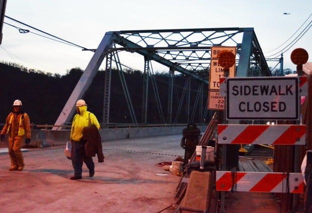 Workers walk off the Ambridge-Aliquippa Bridge last November, shortly before it reopened to traffic for the winter. Monday, PennDOT will begin the second phase of the $16.6 million project to rehabilitate the bridge; that work will mean the bridge will be closed until mid-November.