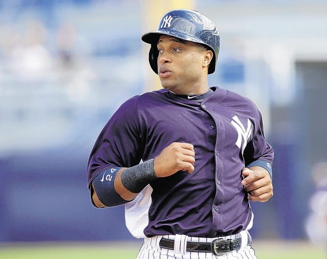New York Yankees' Robinson Cano runs to third base against the Phialdelphia Phillies during a MLB spring training baseball game Friday, March 1, 2013, in Tampa, Fla. (AP Photo/Chris O'Meara)