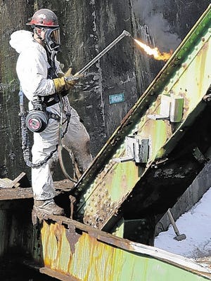 A worker gets ready to cut through part of the old Neversink Bridge Thursday in Cuddebackville. The bridge brought Route 209 over the Neversink River.