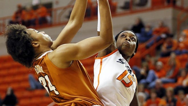 Oklahoma State's Toni Young (15) blocks the shot of Texas' Imani McGee-Stafford (34) during an NCAA college basketball game at Gallagher-Iba Arena in Stillwater, Okla., on Saturday, March 2, 2013.