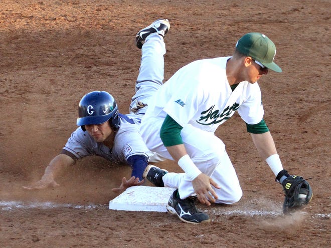 Connecticut's LJ Mazzilli slides into third base Sunday as Stetson's Carlos Garmendia has the ball in his glove at Conrad Park in DeLand.