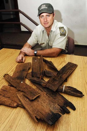 Steven Smith, superintendent of Fort King George State Historic Site in Darien, displays some charred pieces of the old cotton warehouses that were burned during the Civil War. Darien was assaulted by the 54th Massachusetts Union regiment and burned on June 11, 1863. (Terry Dickson/Morris News Service)