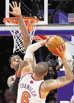 Heat's LeBron James, left, defends against Tyson Chandler during the second half on Sunday at Madison Square Garden.