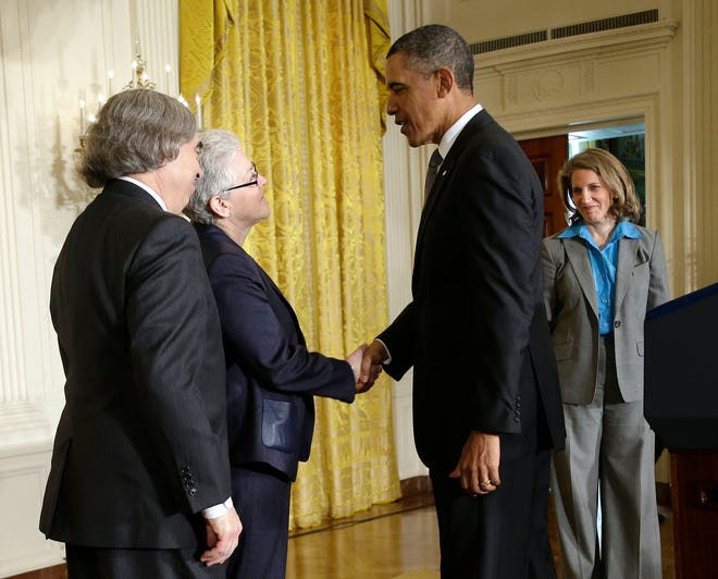 President Barack Obama shakes hands with Regina McCarthy, his nominee to head the Environmental Protection Agency, Monday, March 4, 2013, at the White House. At left is Ernest Moniz, a physics professor at the Massachusetts Institute of Technology and Obama's choice to lead the Energy Department. Sylvia Mathews Burwell, right, was nominated to direct the White House Office of Management and Budget.
