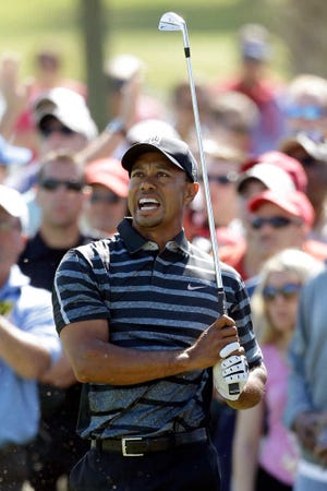 Tiger Woods reacts to his shot on the third fairway during the first round of the Cadillac Championship golf tournament, Thursday, March 7, 2013, in Doral, Fla. (AP Photo/Wilfredo Lee)