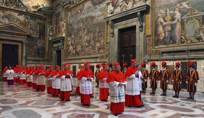 Cardinals enter the Sistine Chapel in Rome for a papal conclave in 2005 in this file photo. The present deliberations are different than the past, with the previous pope still living.