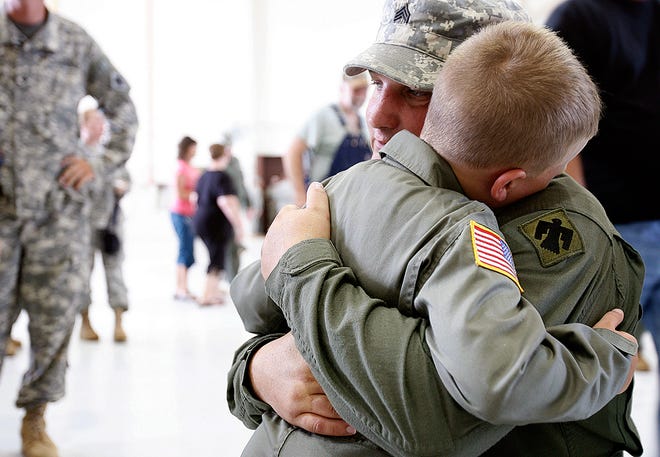 Sgt. David Tillman of Hennessey, Okla., hugs his son Patrick, 7, after the deployment ceremony for the 2-149 General Support Aviation Battalion, 90th Troop Command, Sunday, June, 8, 2008, in Lexington, Okla., at the 90th Troop Command of the Oklahoma Army National Guard. BY SARAH PHIPPS, THE OKLAHOMAN
